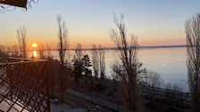 View of the Ganga river from the ashram balcony during a peaceful sunrise.