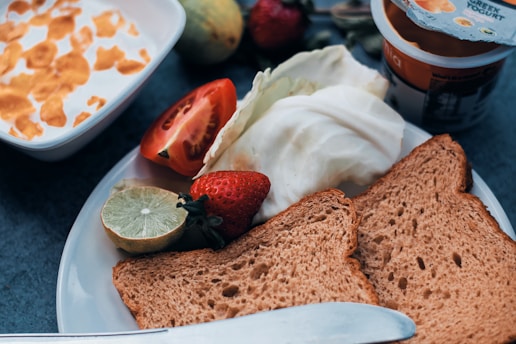 a white plate topped with toast and fruit