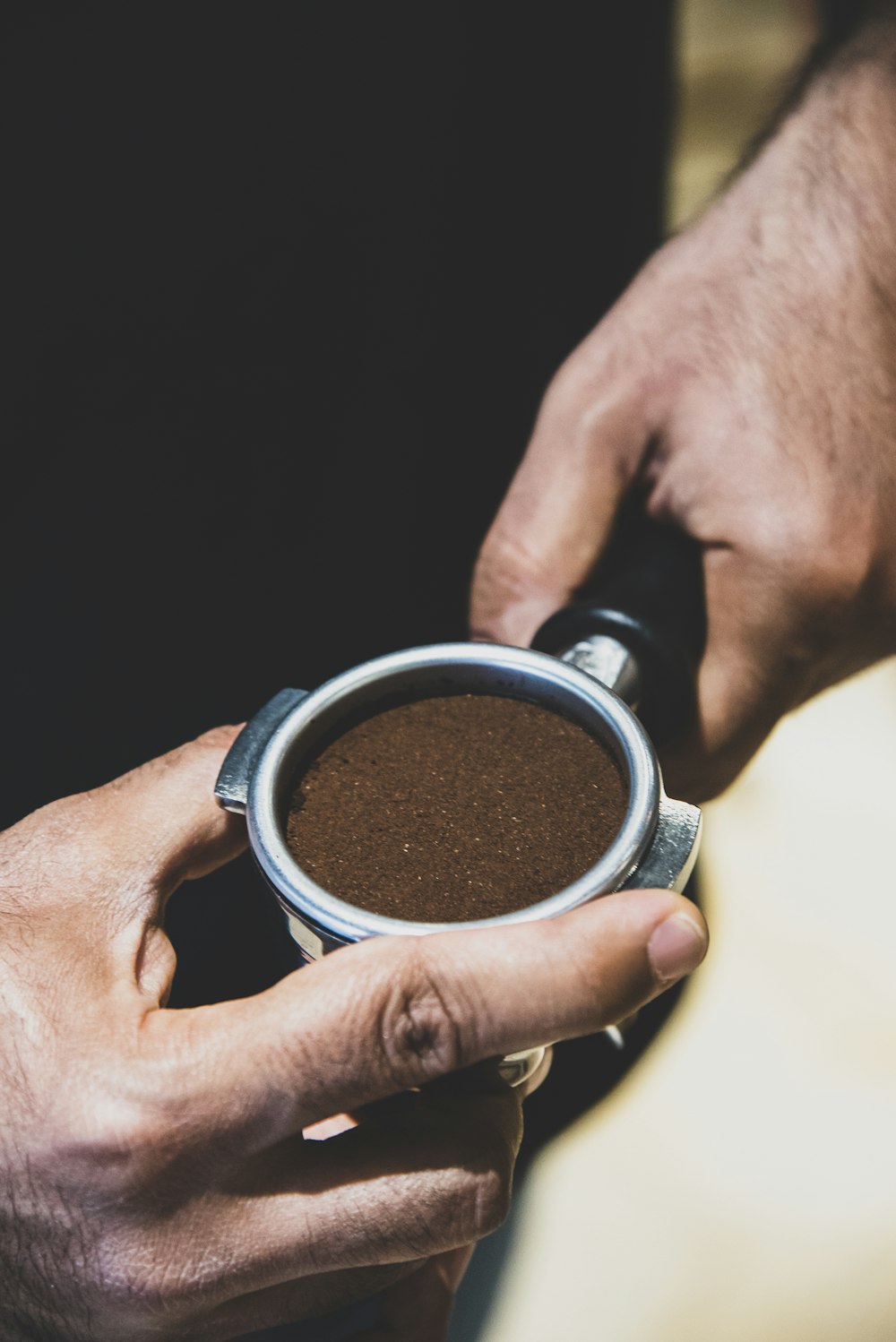 a person holding a cup of coffee in their hands