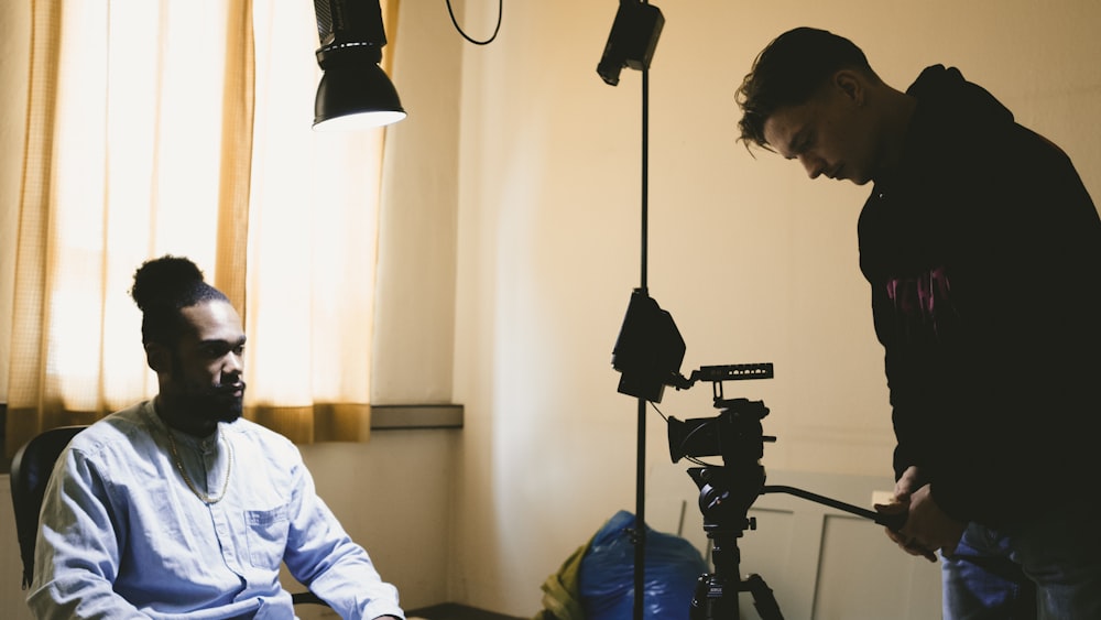 a man sitting in a chair in front of a camera