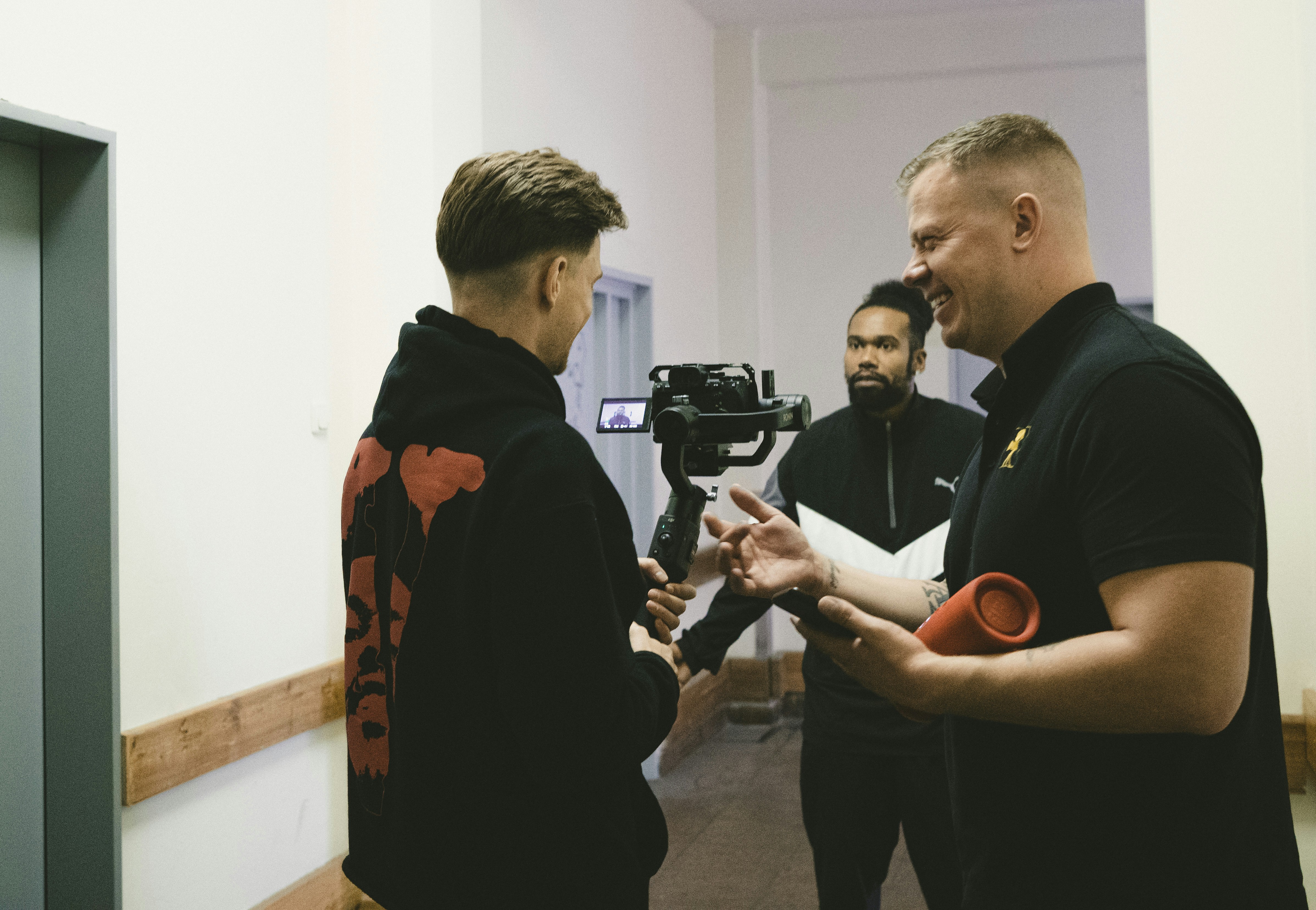 a group of men standing next to each other in a room