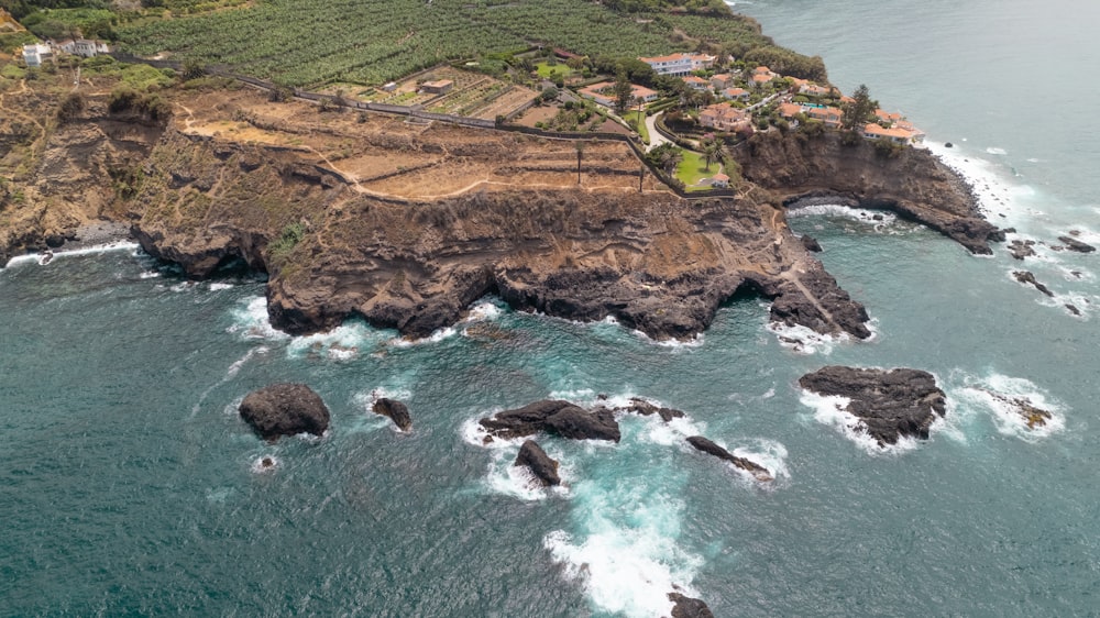 an aerial view of the ocean with a small island in the middle