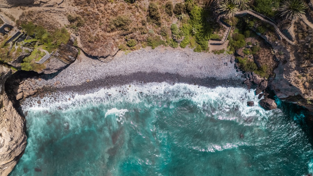 an aerial view of a beach and a cliff