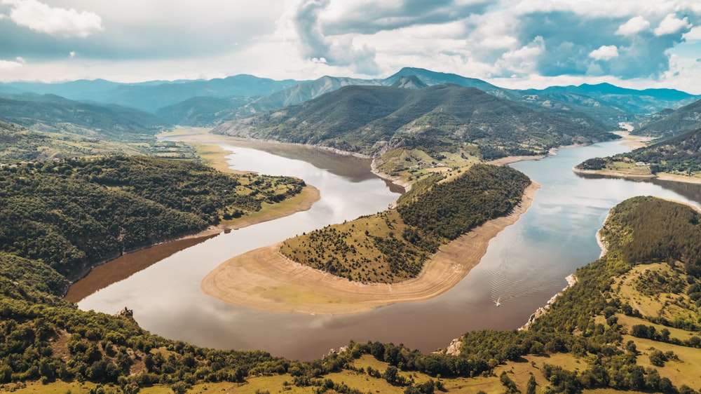 an aerial view of a lake surrounded by mountains