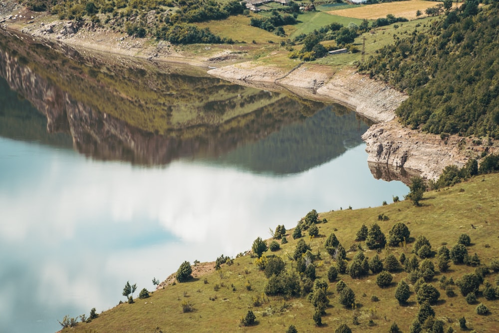 an aerial view of a lake surrounded by trees