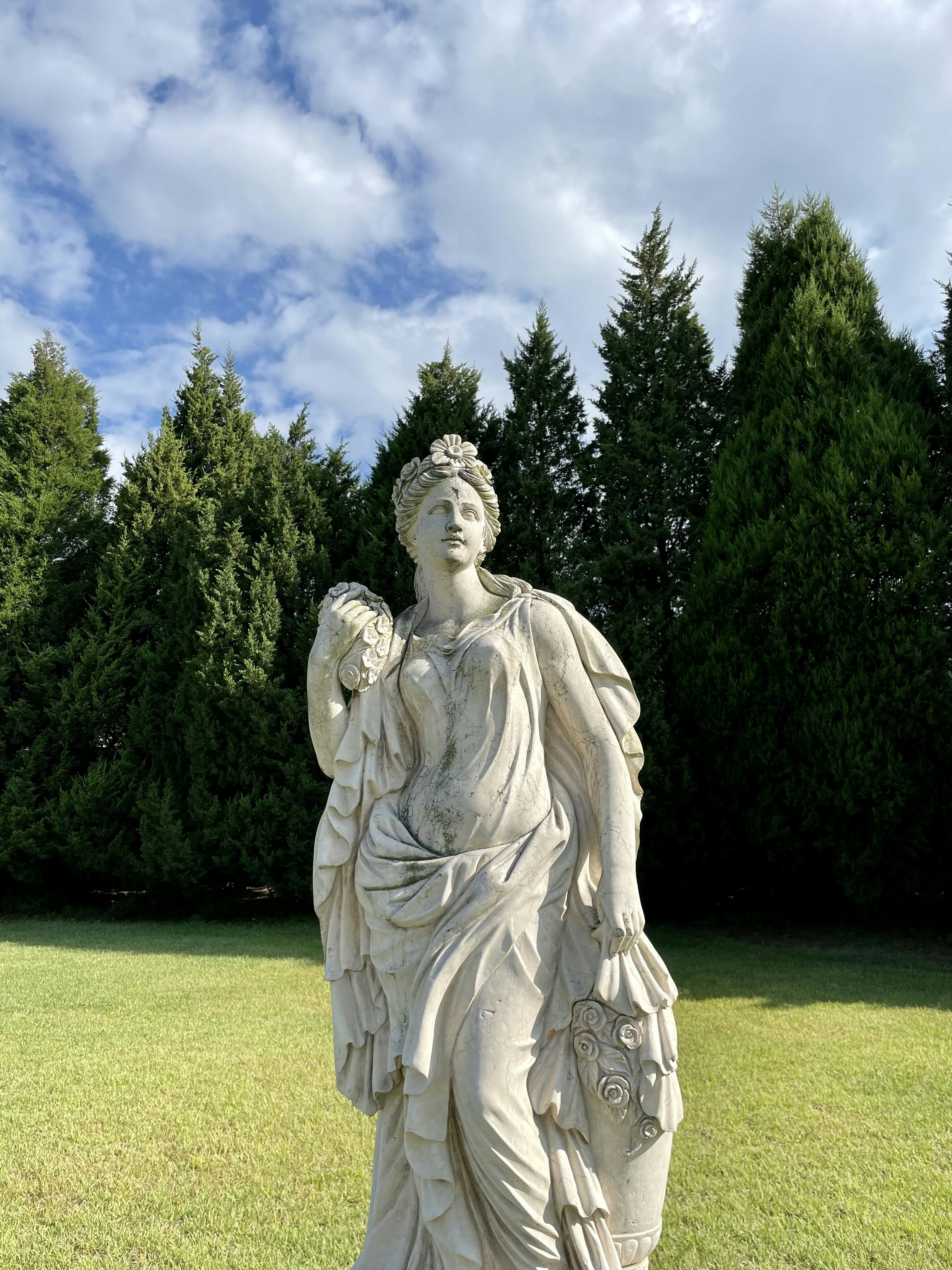 Una estatua de una mujer sosteniendo una flor