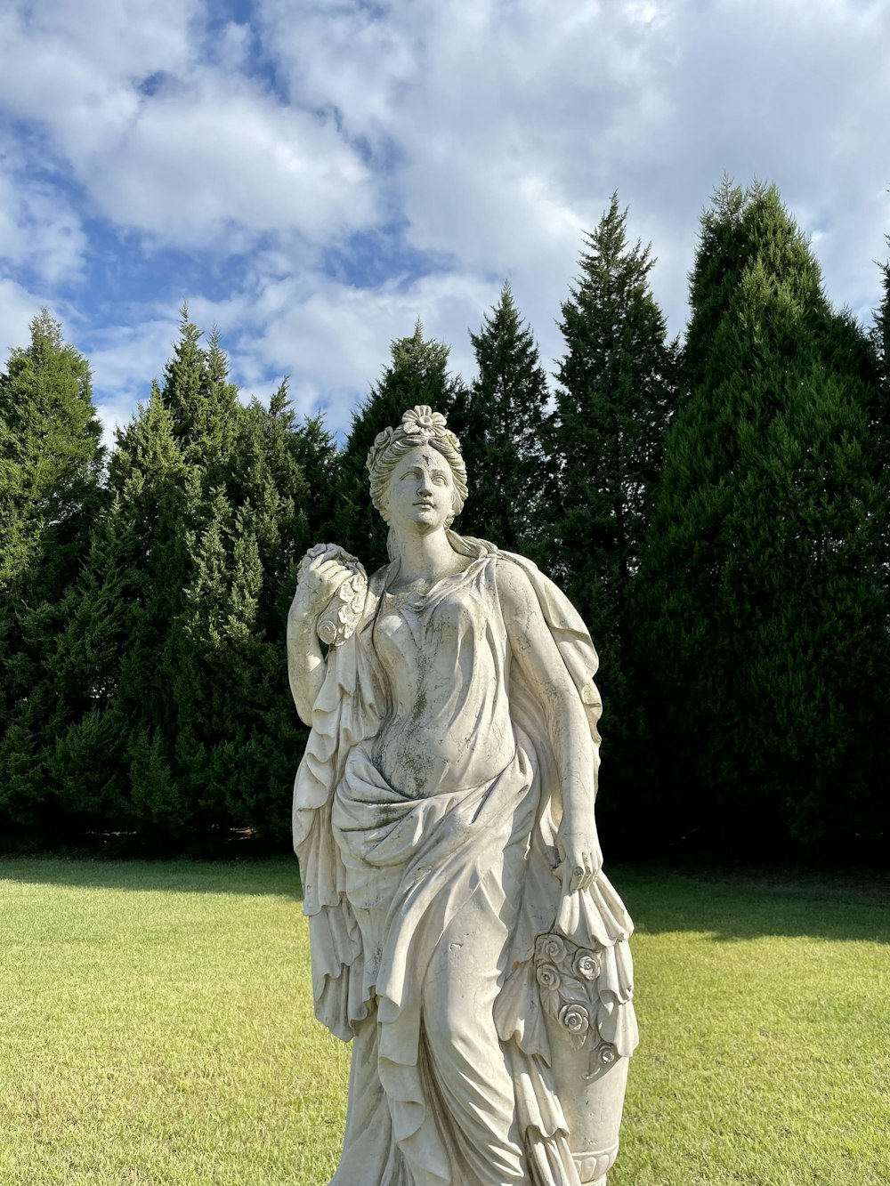 a statue of a woman holding a flower