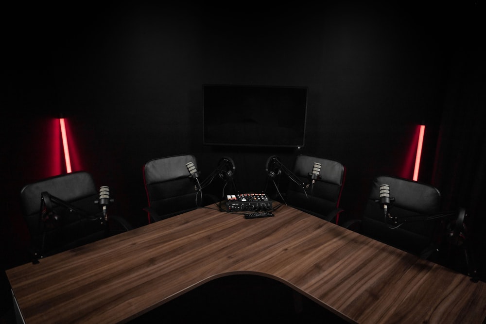 a dark room with a wooden table and chairs