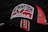 A baseball cap featuring the logo and colors of the Washington Capitals ice hockey team. The cap is predominantly black and red with the team's name and emblem embroidered on the front. The mesh back of the cap is red, and a large number 8 is stitched on the brim.