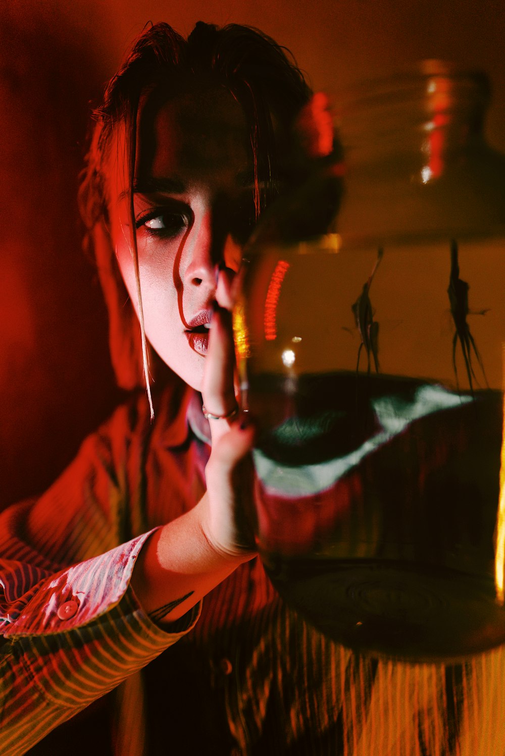 a woman holding a bowl with a liquid inside of it