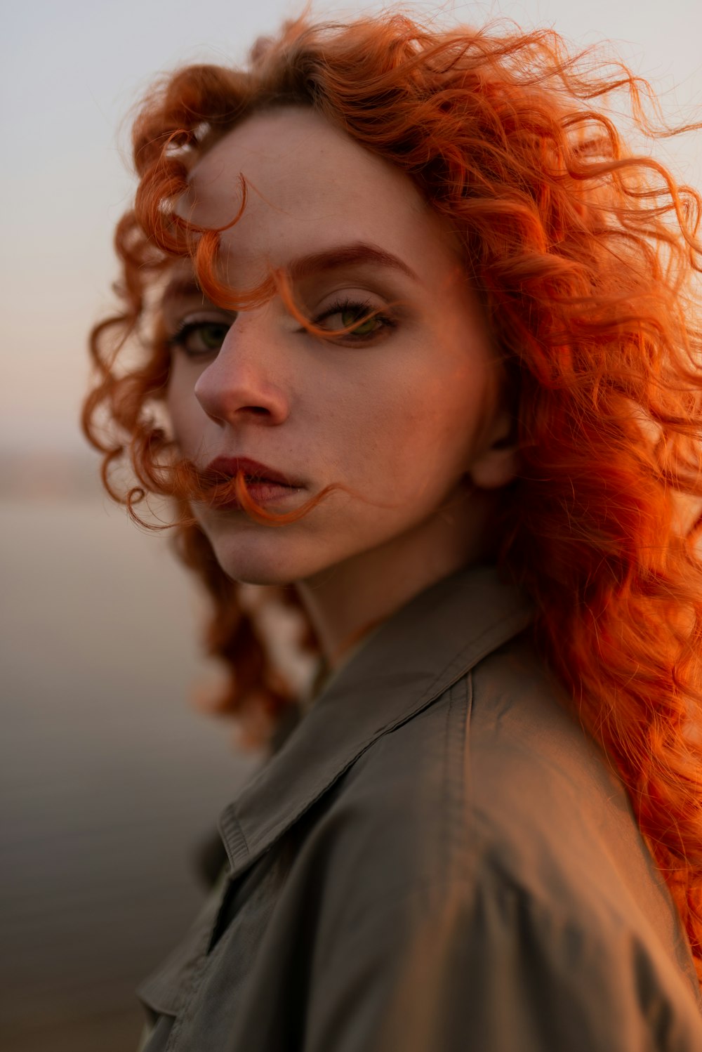 a woman with red hair and a moustache on her face