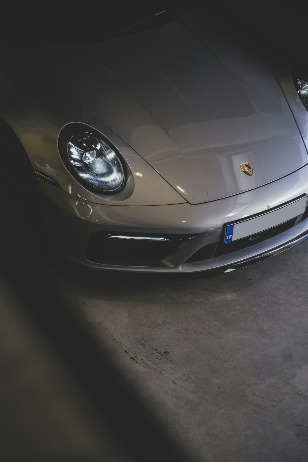 a silver sports car parked in a garage