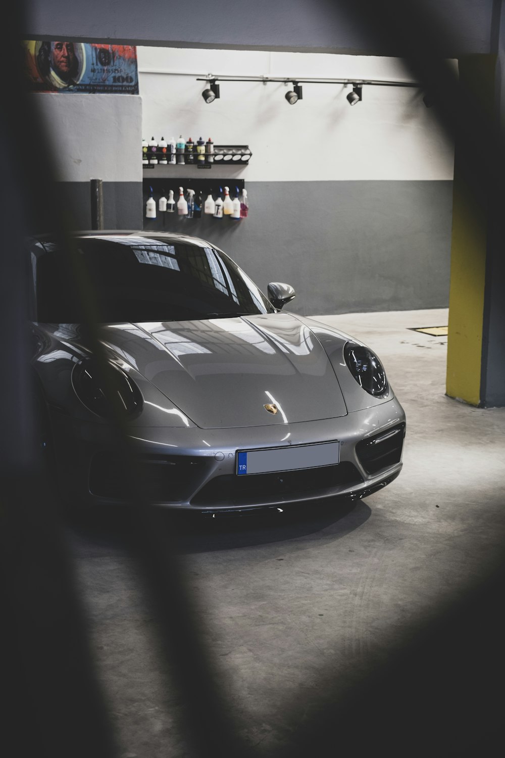 a silver sports car parked in a garage