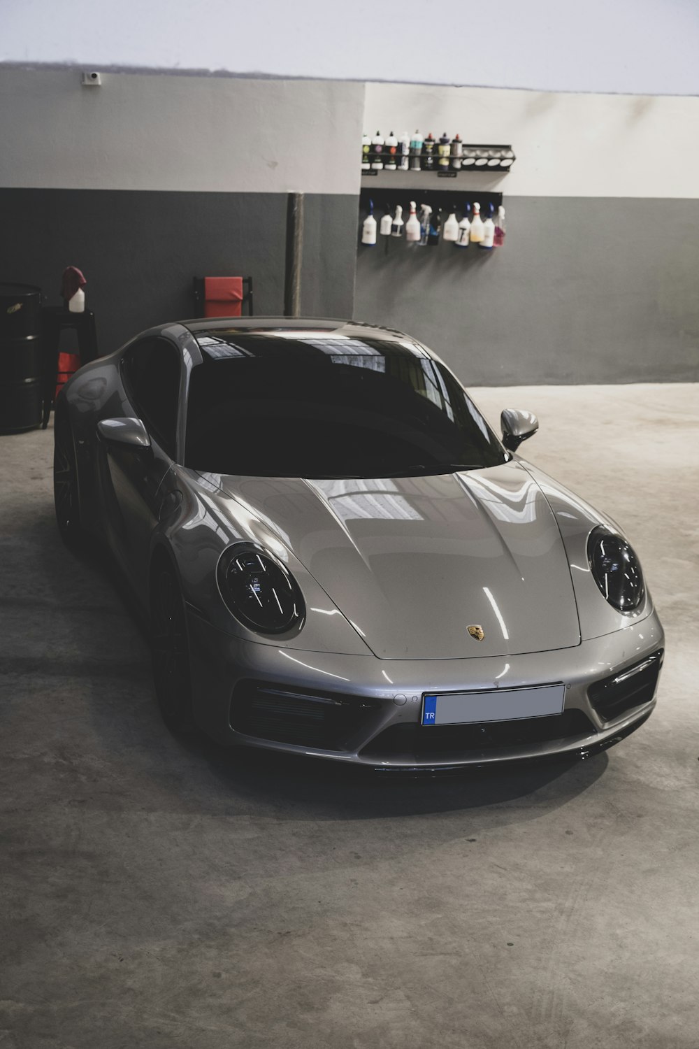 a silver sports car parked in a garage