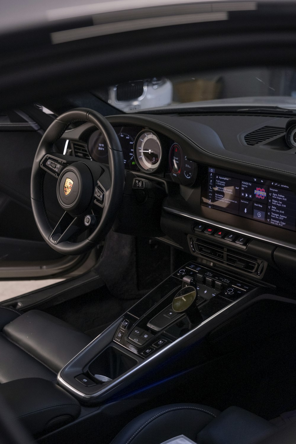 the interior of a car with a steering wheel and dashboard