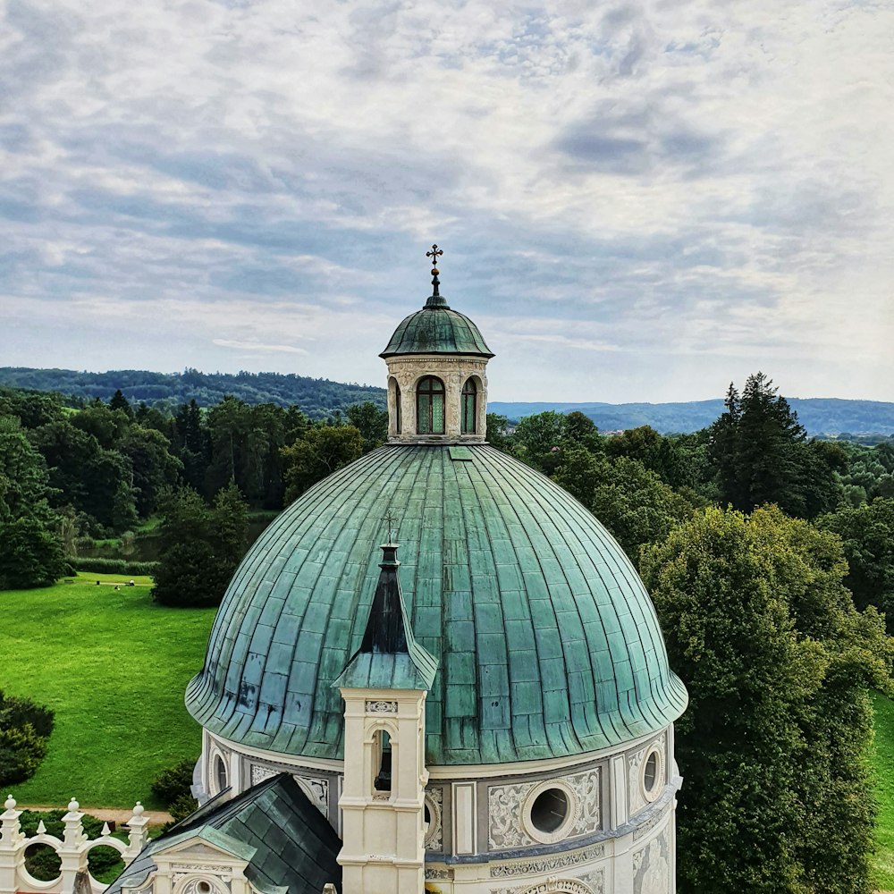 an aerial view of a church with a green roof