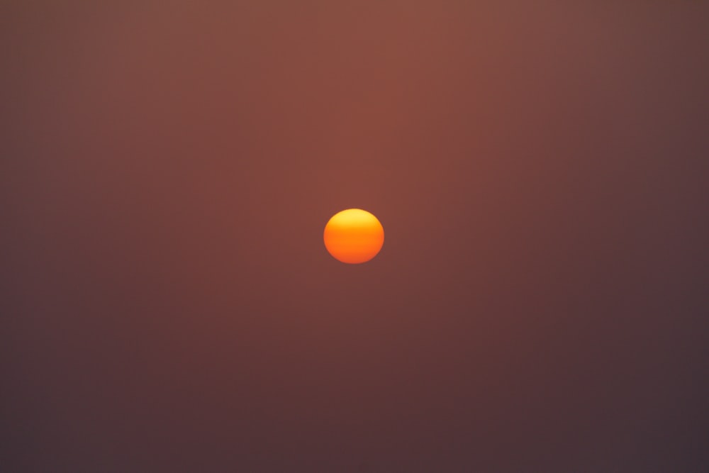 the sun is setting on a hazy day