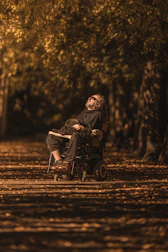 A person using a wheelchair outdoors, enjoying fresh air and movement.