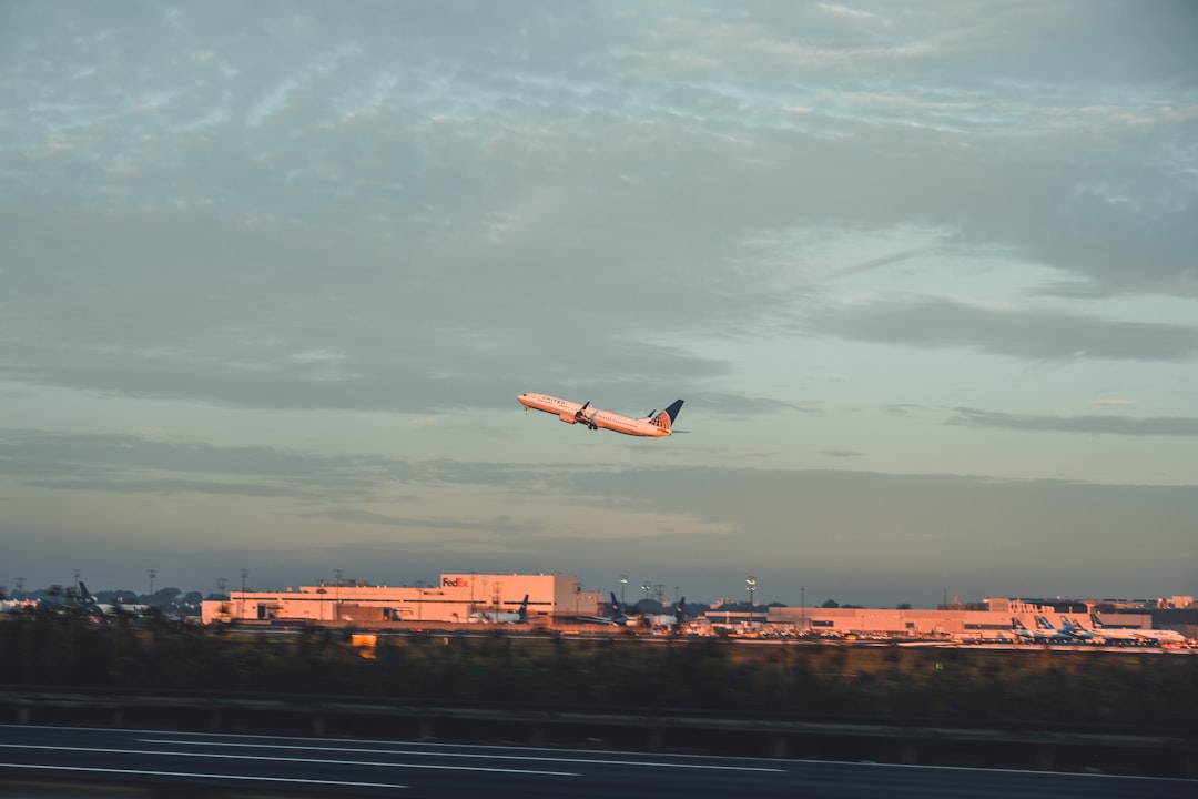 an airplane is flying low over a city, Away