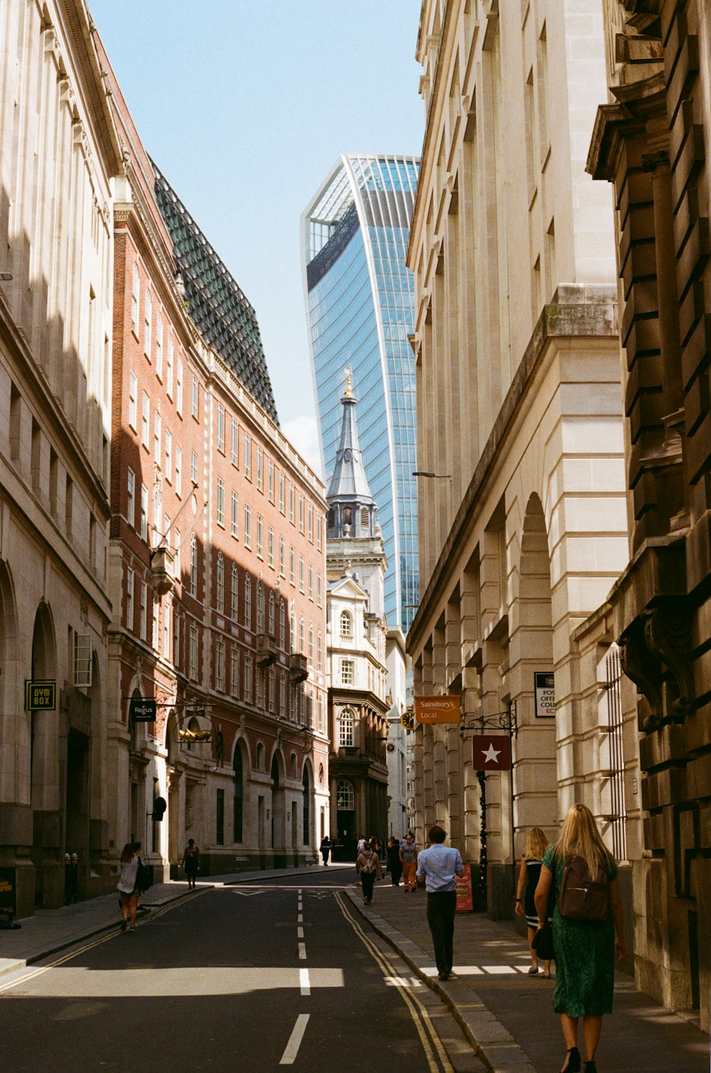 a city street with people walking down it