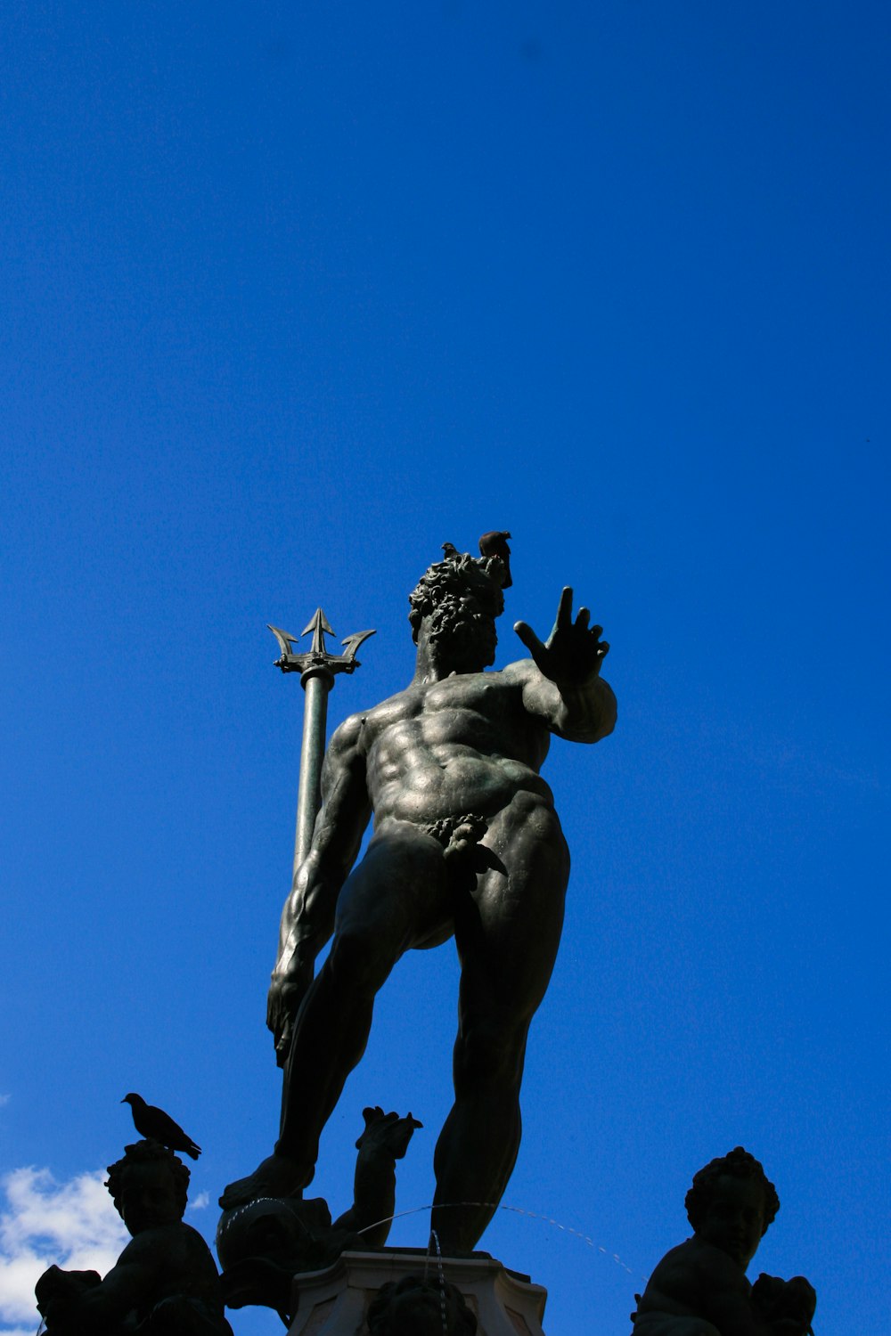 a statue of a man holding a cross on top of a building