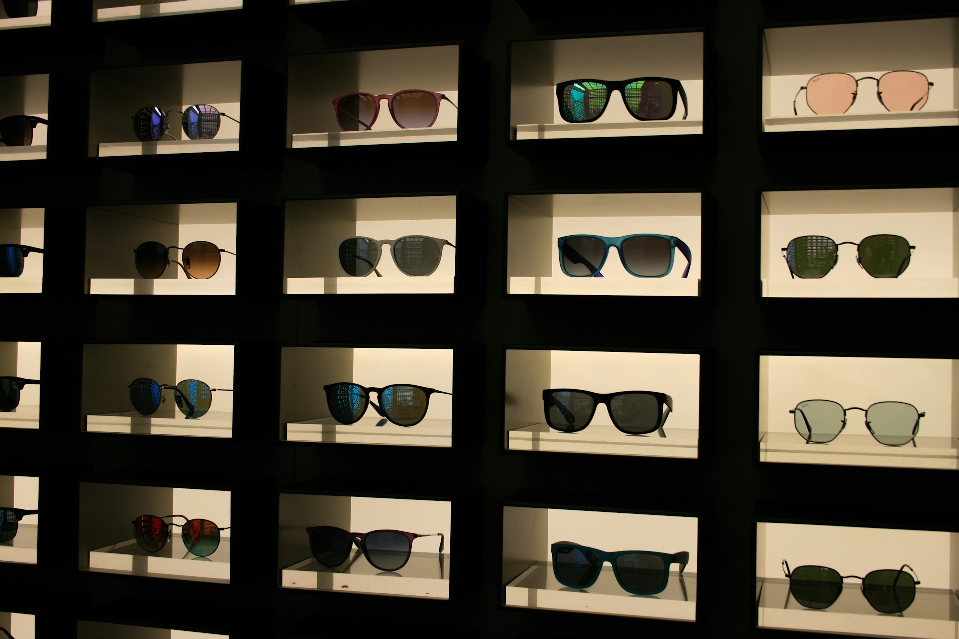 a display case filled with lots of different colored sunglasses