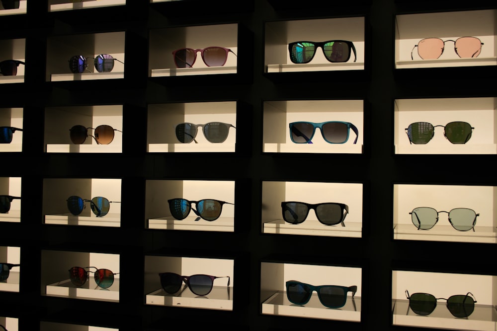 a display case filled with lots of different colored sunglasses