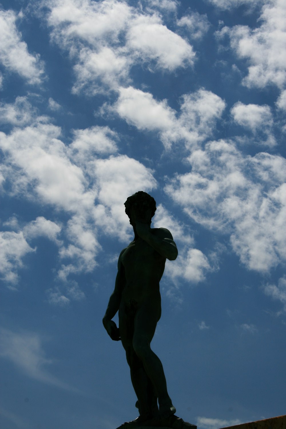 a statue of a man standing on top of a rock