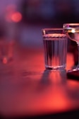 Soft lighting illuminating a sophisticated wine glass on a charcoal gray table.