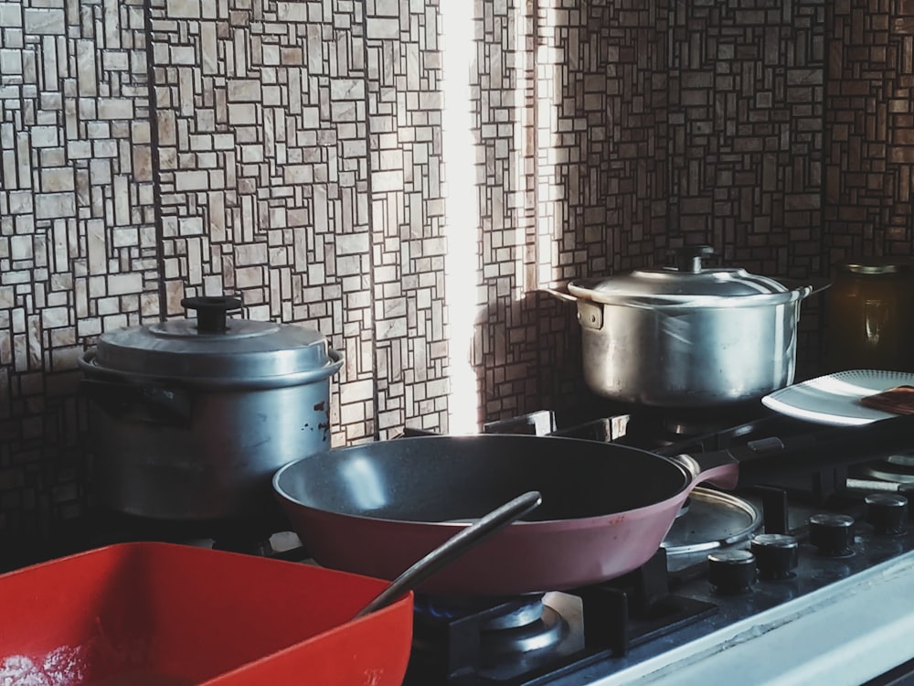 pots and pans are sitting on a stove top
