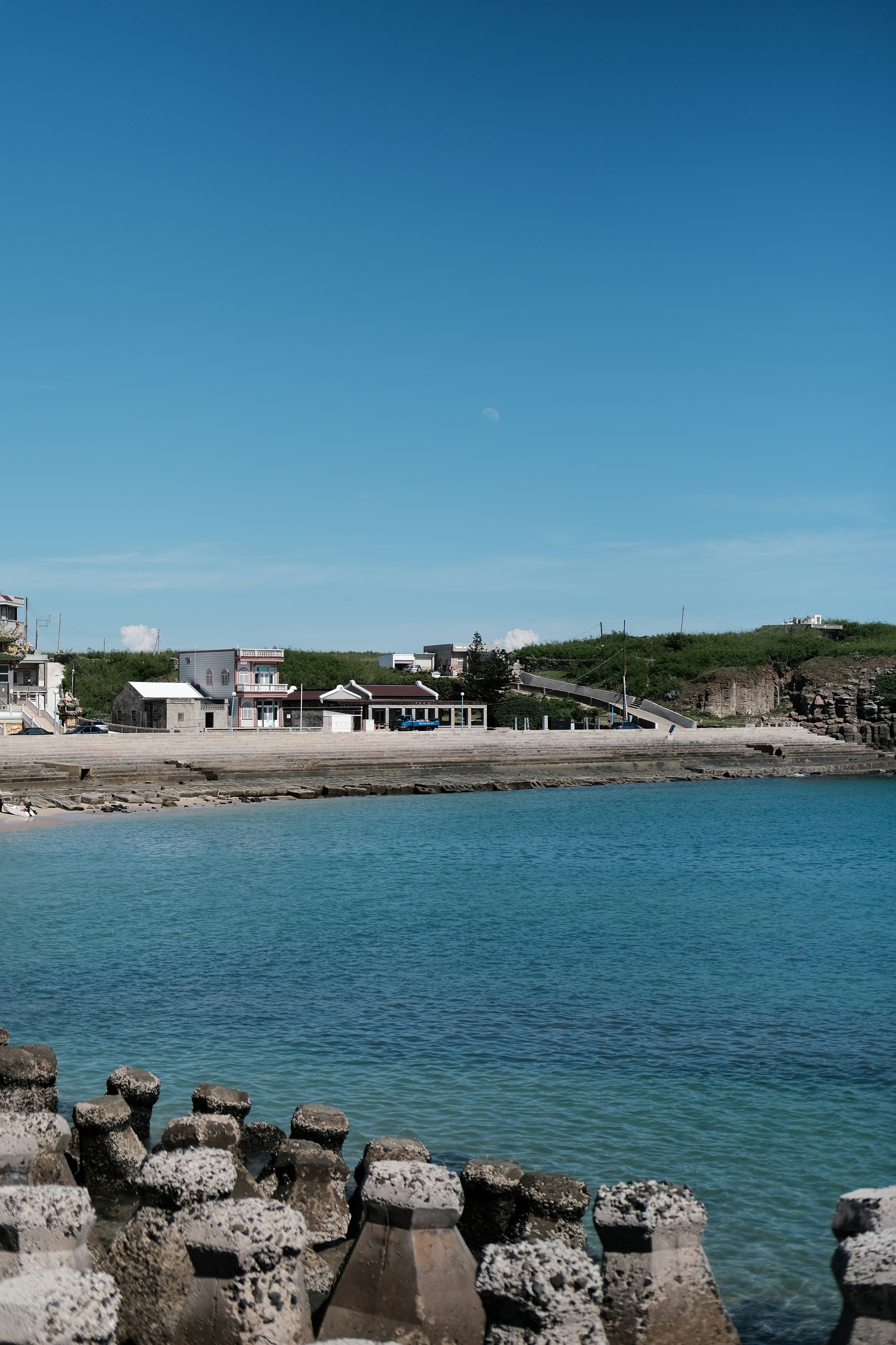 a body of water next to a sandy beach