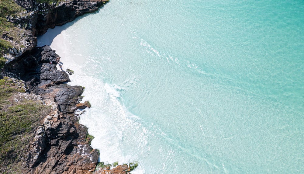 an aerial view of a beach and a cliff