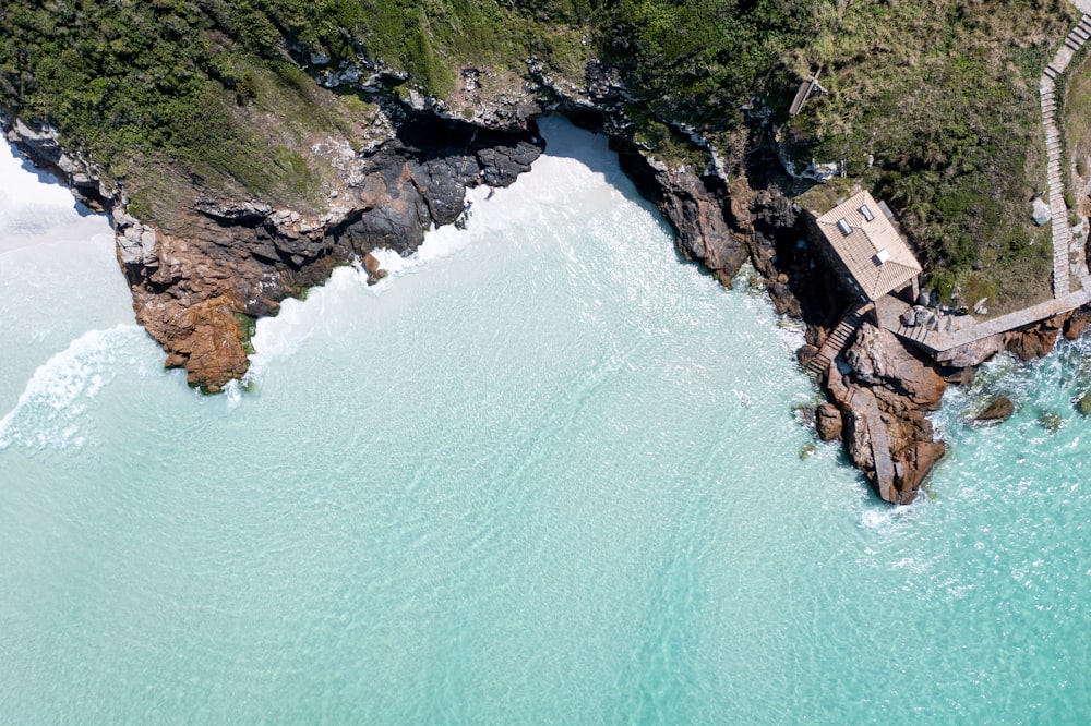 an aerial view of a beach with a pier