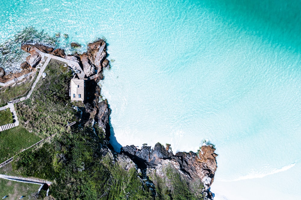 Una veduta aerea di un castello su una scogliera accanto a uno specchio d'acqua