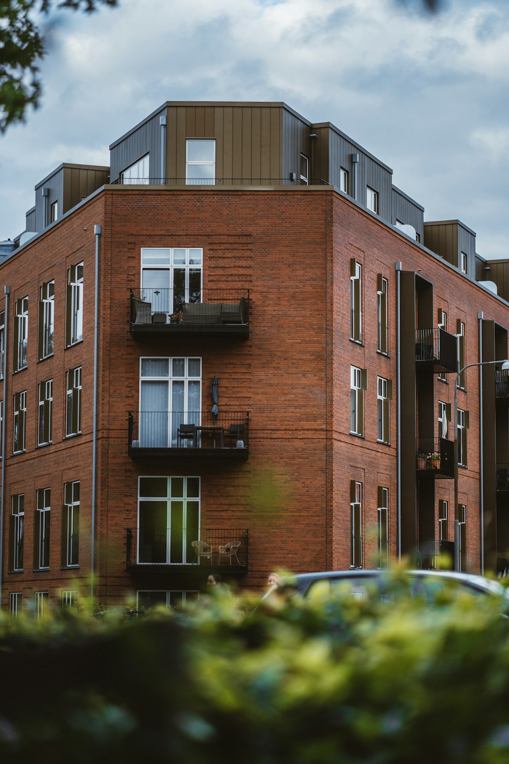 a tall brick building with balconies and balconies on the top of