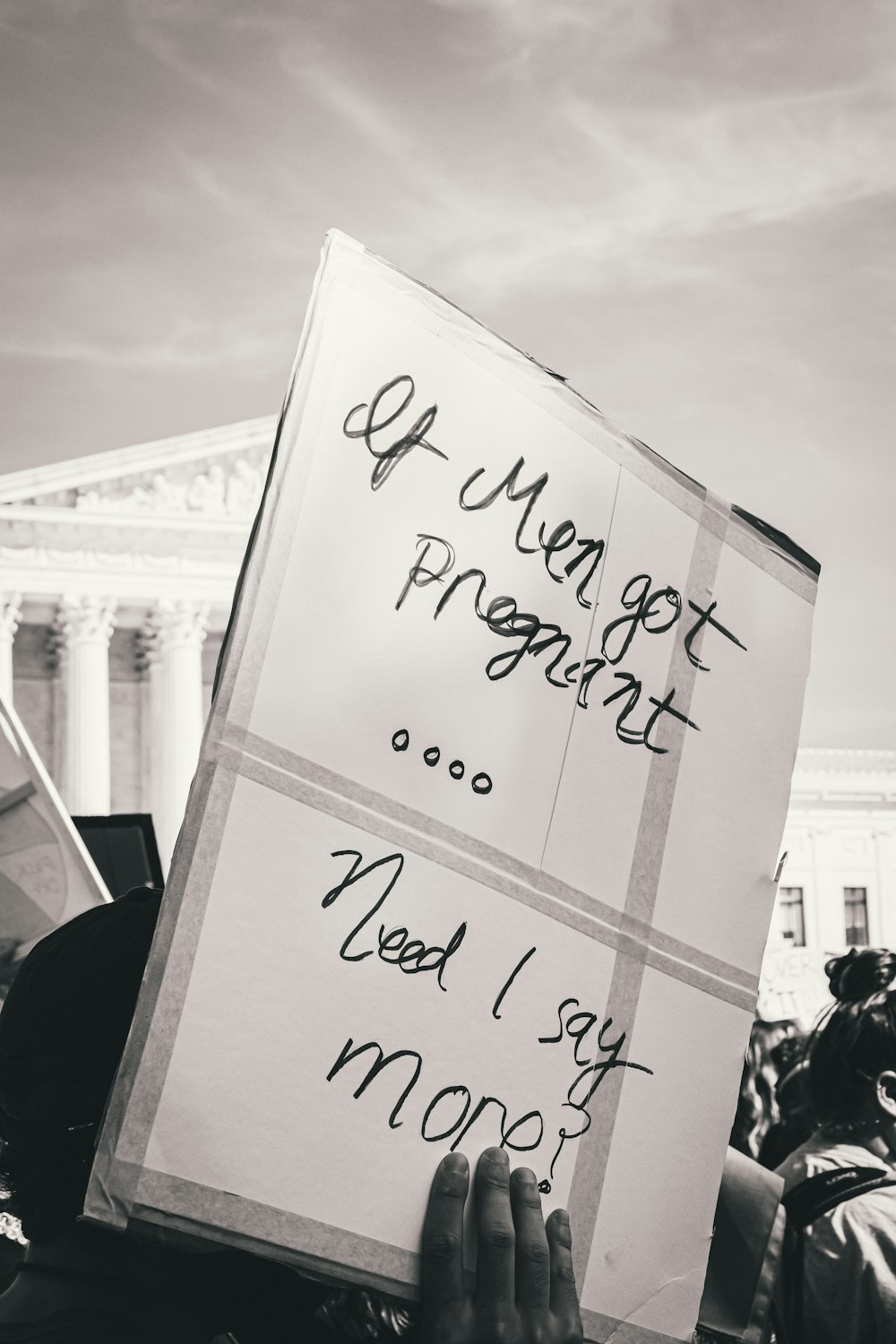 a protester holding a sign that reads, i'm not gay, i