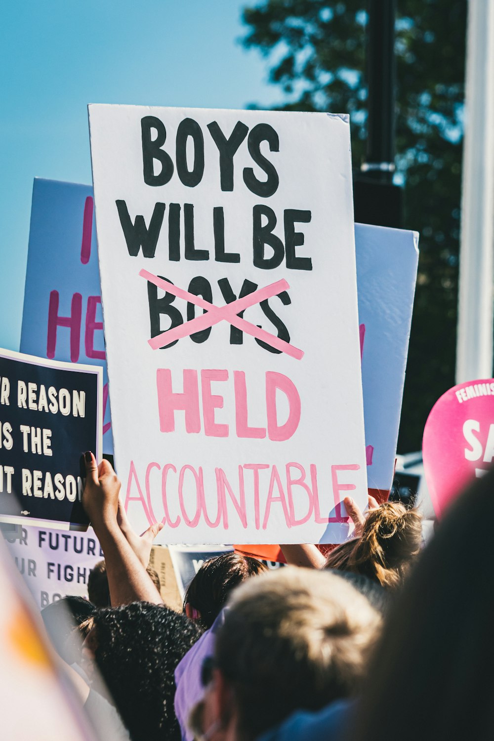 a group of people holding up signs in the air