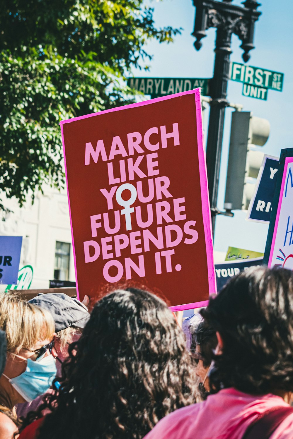 a group of people holding a sign that says march like your future begins on it