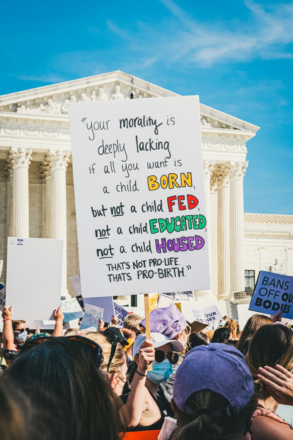 a group of people holding signs in front of a building