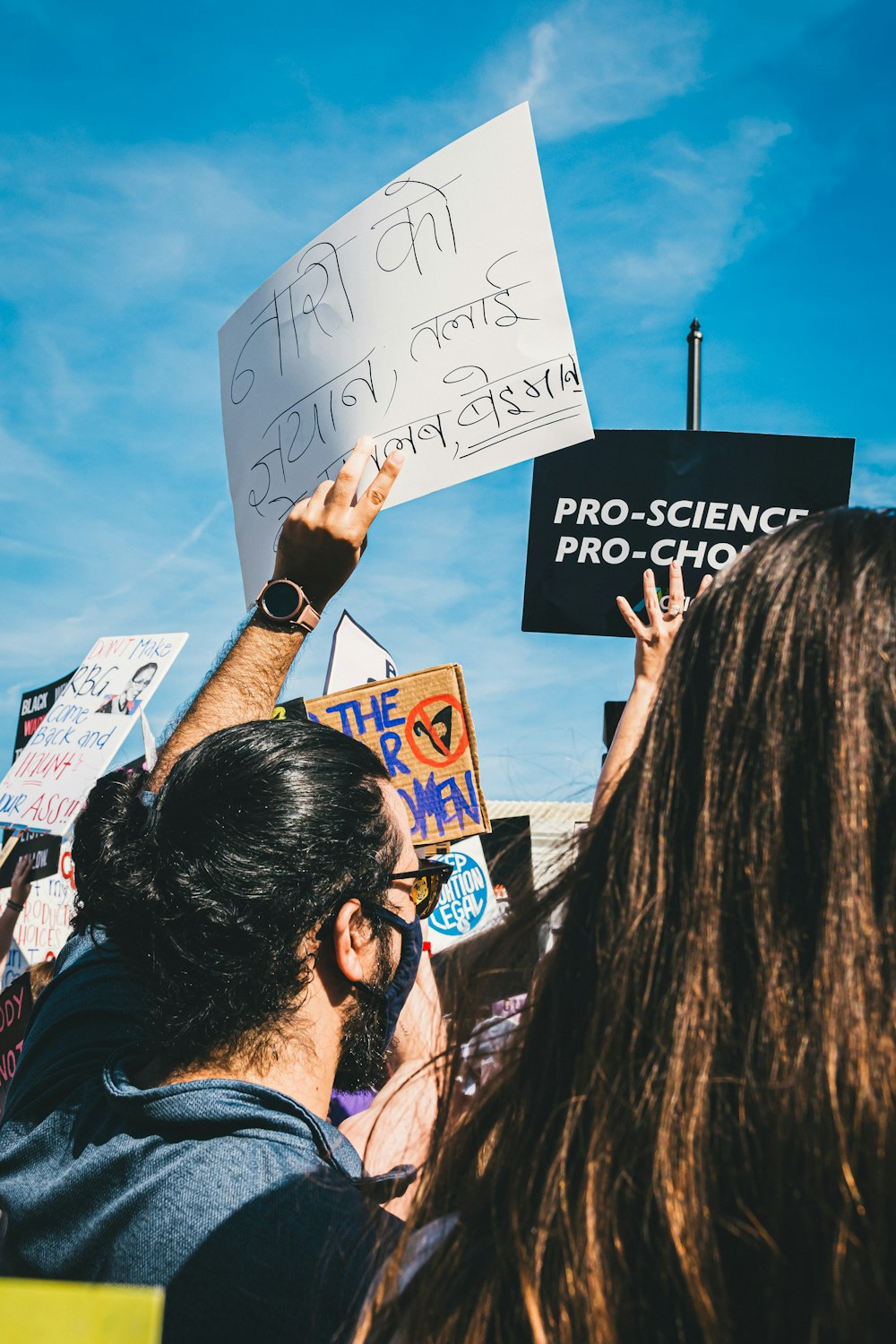 a group of people holding up signs in the air