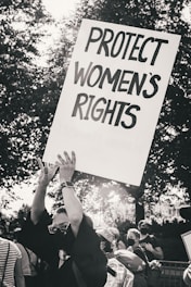 a protester holding a sign that reads protect women's rights