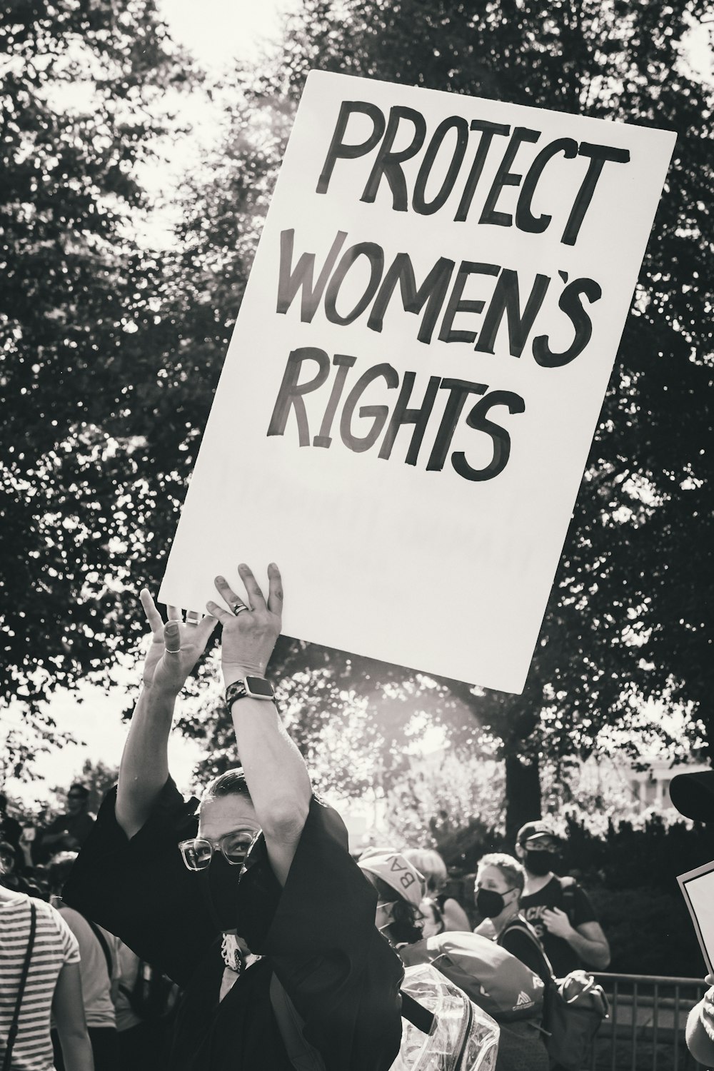 Un manifestant tenant une pancarte sur laquelle on peut lire Protégeons les droits des femmes