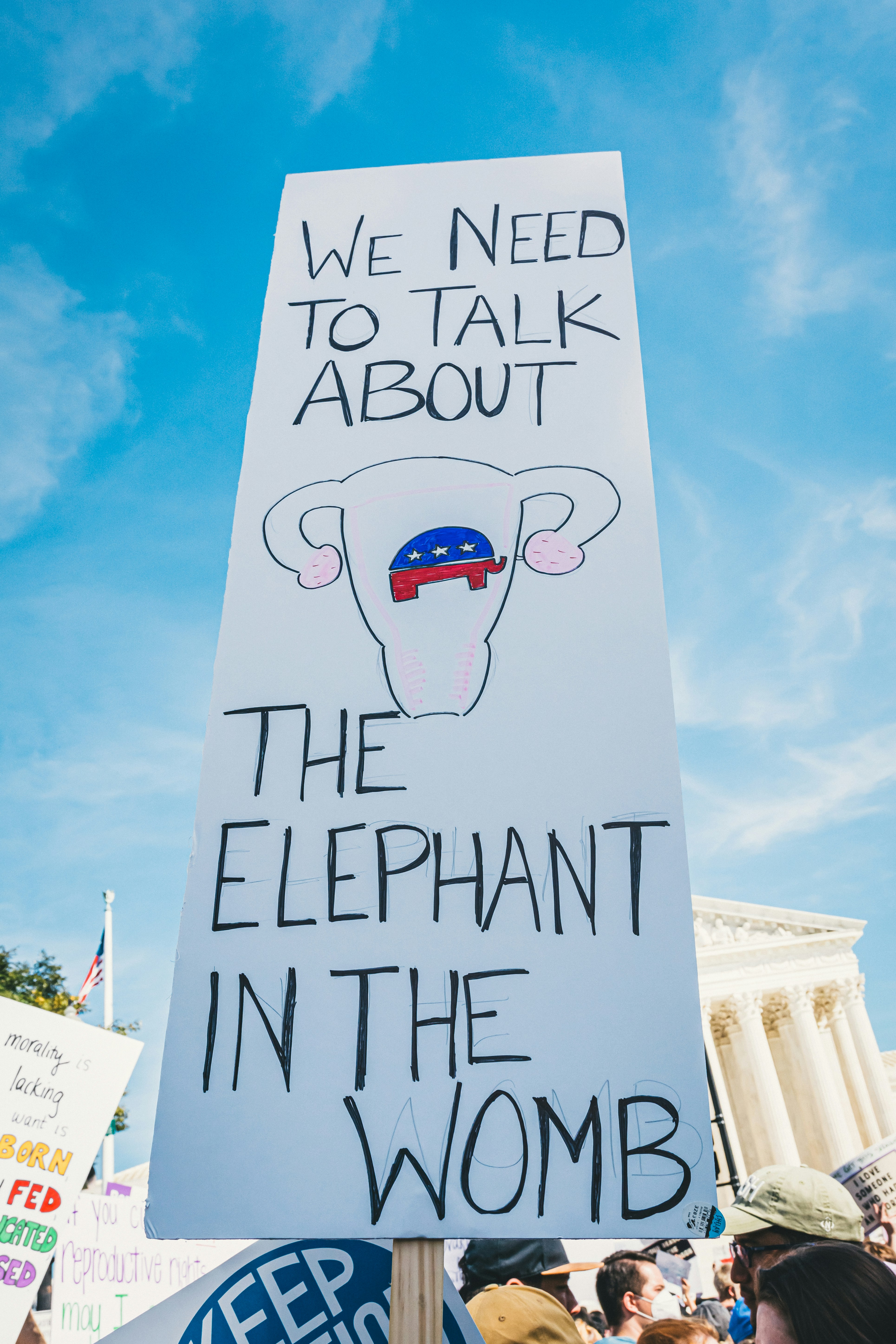 a protest sign that reads we need to talk about the elephant in the women '