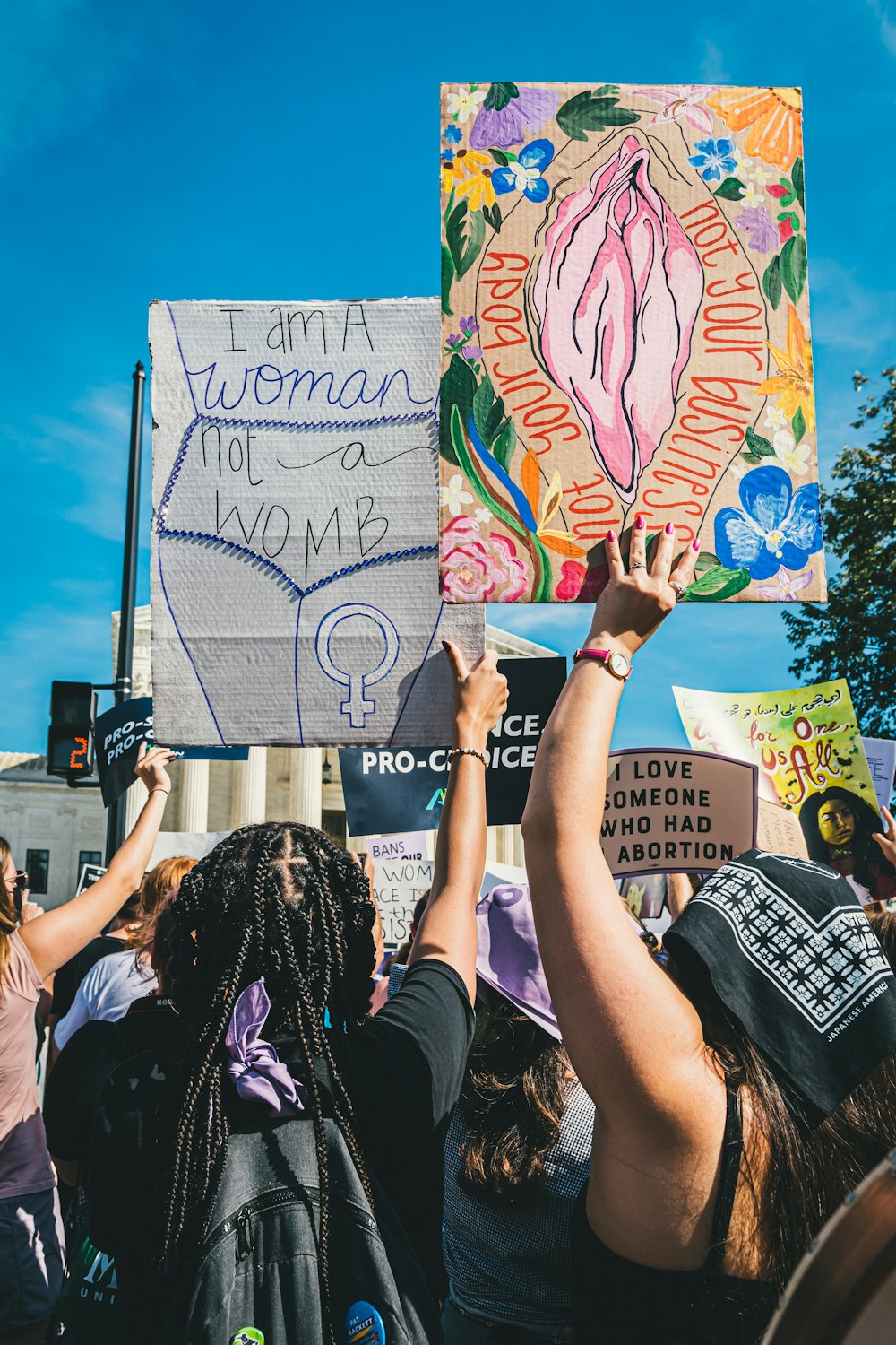 a group of people holding up signs in the air