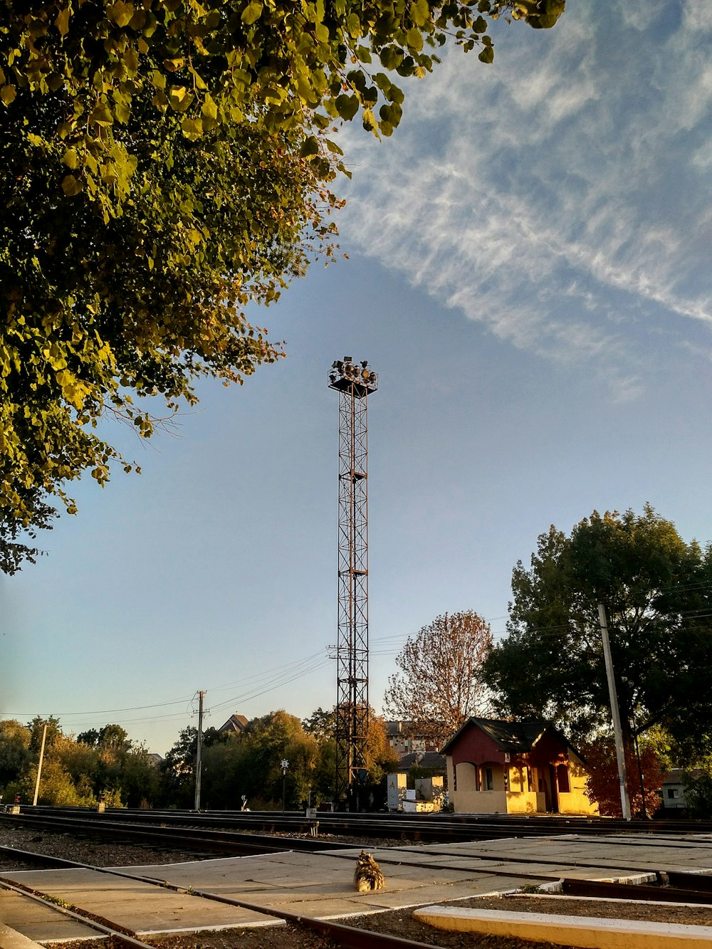 a train track with a tower in the background