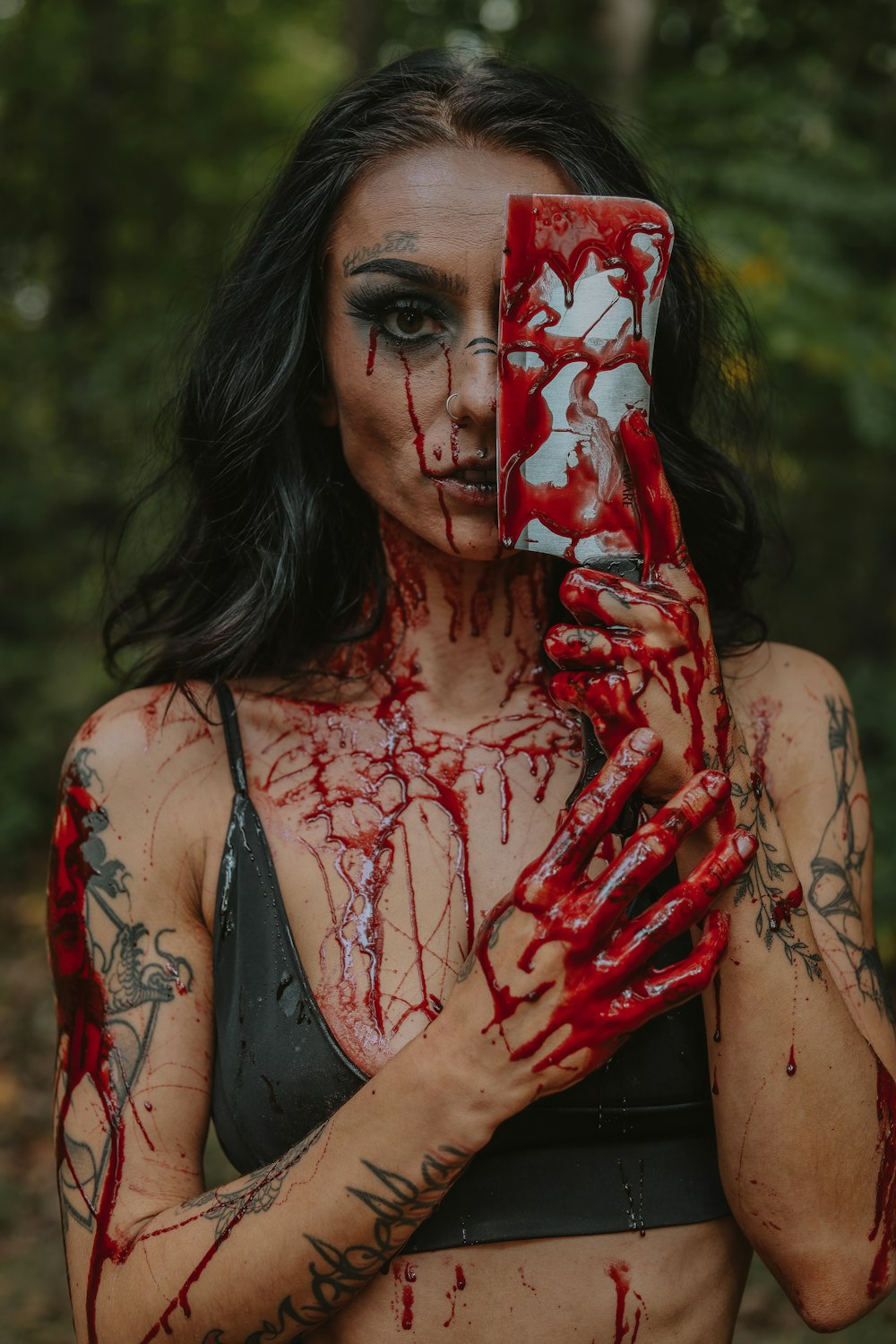 a woman holding a cell phone covered in blood