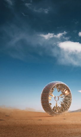 a large tire sitting in the middle of a desert