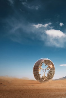 a large tire sitting in the middle of a desert