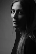 a black and white photo of a woman with long hair