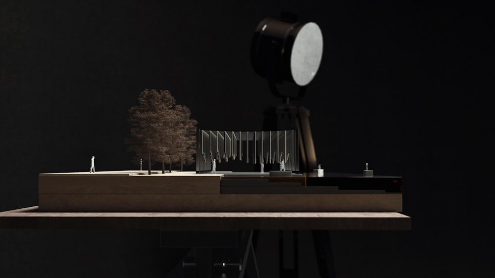 a desk with a light on it and a tree in the background